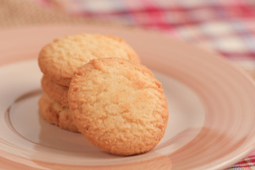 Round sweet cookies. Delicious dessert with high sugar and carbohydrate suitable for eating with milk and tea or coffee on color and white background with colorful placemat