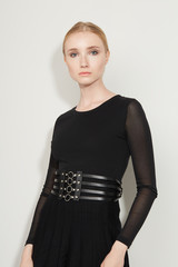 Cropped front view shot of a blond girl, wearing black dress with transparent sleeves and black...