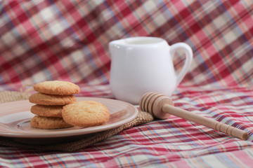 Round sweet cookies. Delicious dessert with high sugar and carbohydrate suitable for eating with milk and tea or coffee on color and white background with colorful placemat