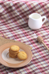 Round sweet cookies. Delicious dessert with high sugar and carbohydrate suitable for eating with milk and tea or coffee on color and white background with colorful placemat