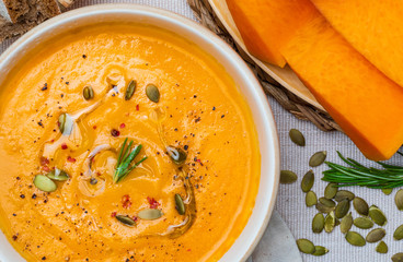 Delicious pumpkin cream. Home and rustic appearance. Includes fresh pumpkin, seeds and rye bread. Aerial view.