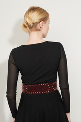 Cropped back view shot of a blond girl, posing on a white background. She is wearing black gown...