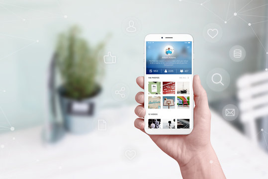 Social network app concept on mobile phone in hand surrounded with concept icons and network.