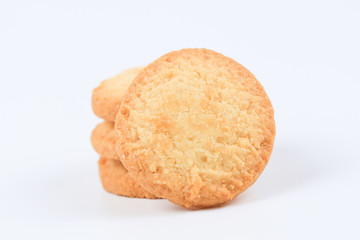 Round sweet cookies. Delicious dessert with high sugar and carbohydrate suitable for eating with milk and tea or coffee on color and white background with colorful placemat