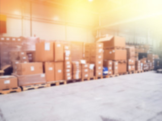 Warehouse industrial and logistics companies. blurry, lots of boxes, Commercial warehouse. Boxes and crates stocked on the shelves of three storey. The effect of motion blur. Bright sunlight.