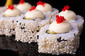 Japanese Sushi Rolls with Cream Cheese , flying fish roe and sesame seeds