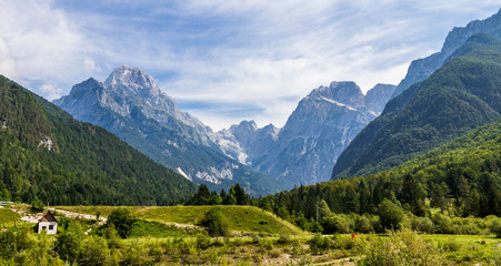 Fototapeta na wymiar Panoramic of Mangart-Jalovec Mountain Massive in the Julian Alps inside beautiful Landscape. Log pod Mangartom, Bovec, Slovenia, Europe.