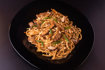 noodles with beef and shiitake mushrooms on the plate