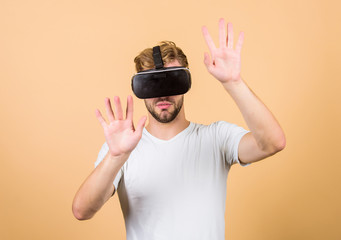 Virtual simulation. VR for gaming. Man play game in VR glasses. Explore cyber space. Man hipster...