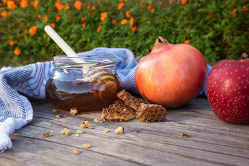 Jewish National Holiday. Rosh Hashana with honey, apple and pomegranate on wooden table.