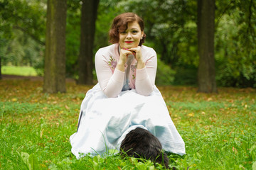 Pretty vintage woman walking with her black cat maine coon in the park. scared maine coon black cat...