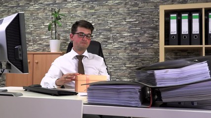 accountant received a gift and rejoicing opens it at the workplace