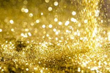 Sprinkle glitter gold dust sand in the dark textured abstract background elegant for Merry christmas and Happy new year