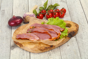 Sliced smoked duck breast served salad