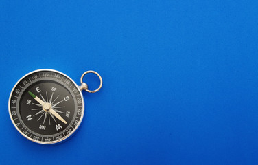 Compass on blue background with copy space