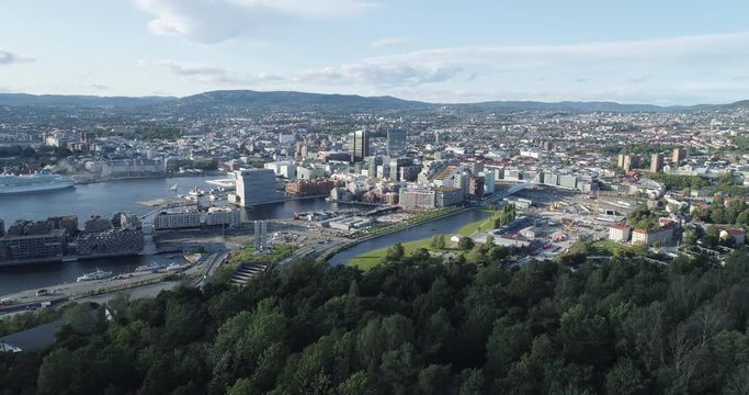 Cinema 4K drone shot with forward reveal motion and panorama view of the Oslo city line and construction in Bjoervika, a tourist attraction with the Munch museum, Soerenga and Barcode, in Norway.