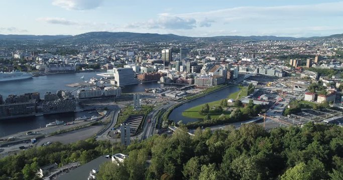 Cinema 4K drone shot with forward reveal motion and panorama view of the Oslo city line and construction in Bjoervika, a tourist attraction with the Munch museum, Soerenga and Barcode, in Norway.