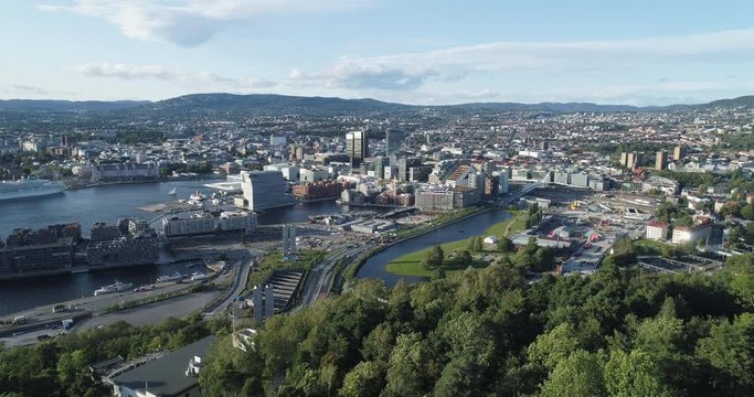 Cinema 4K drone shot with forward reveal motion and panorama view of the Oslo city line and construction in Bjoervika, a tourist attraction with the Munch museum, Soerenga and Barcode, in Norway.