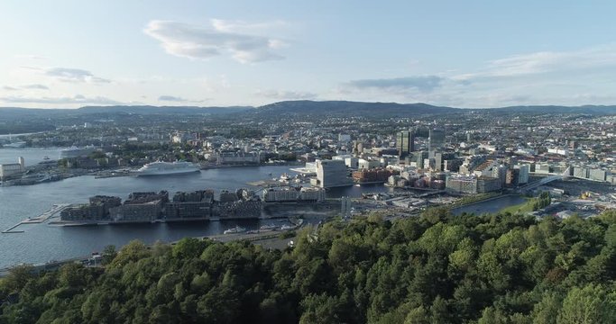 Cinema 4K drone shot with forward reveal motion and panorama view of the Oslo city line and construction in Bjoervika, a tourist attraction with the Munch museum, Soerenga and Barcode, in Norway.
