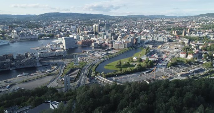 Cinema 4K drone shot with backward reveal motion and panorama view of the Oslo city line and construction in Bjoervika, a tourist attraction with the Munch museum, Soerenga and Barcode, in Norway.