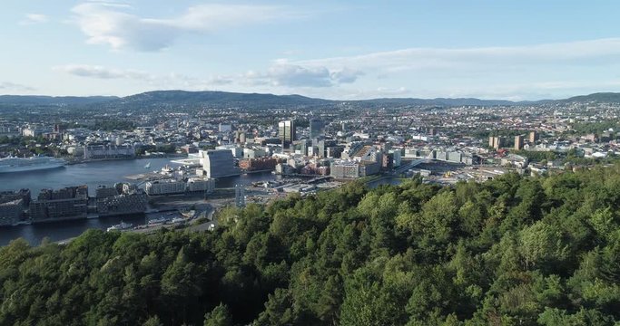 Cinema 4K drone shot with forward reveal motion and panorama view of the Oslo city line and construction in Bjoervika, a tourist attraction with the Munch museum, Soerenga and Barcode, in Norway.