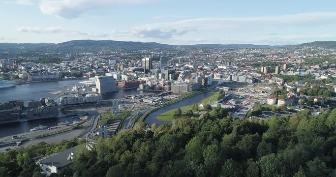 Cinema 4K drone shot with backward reveal motion and panorama view of the Oslo city line and construction in Bjoervika, a tourist attraction with the Munch museum, Soerenga and Barcode, in Norway.