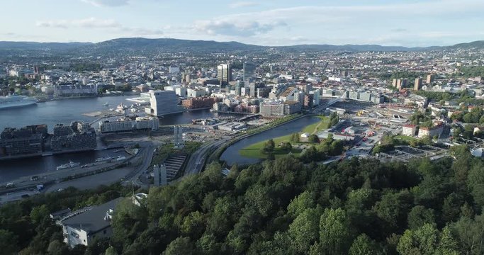 Cinema 4K drone shot with forward reveal motion and panorama view of the Oslo city line and construction in Bjoervika, a tourist attraction with the Munch museum, Soerenga and Barcode, in Norway.