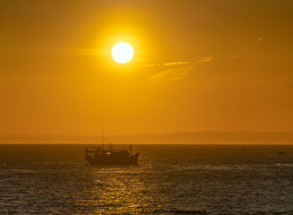 Fototapeta na wymiar Sea landscape at sunset when fishing boats out to sea to harvest fish end the day.