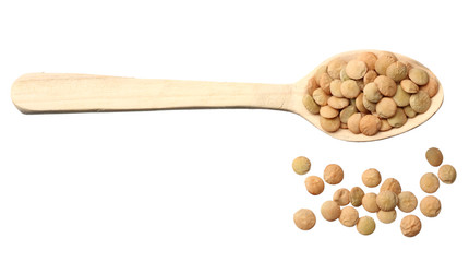 Pile lentil in wooden spoon isolated on white background. Top view.