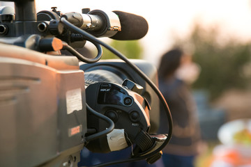 TV Camera and presenter host on a live news broadcast on location