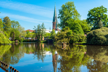 View of the pond and St. Lamberti Church of Oldenburg, Germany.