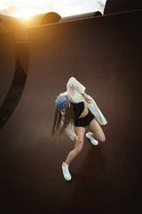 Urban hip hop style dancer practicing dance moves in industrial zone.