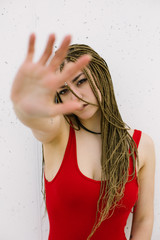 Tough urban young woman doing stop gesture with her hand.