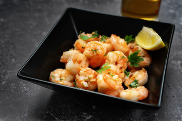 Close up of fried prawns in a black square plate