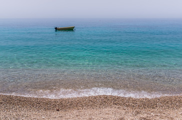 Small boat on the turqoise sea