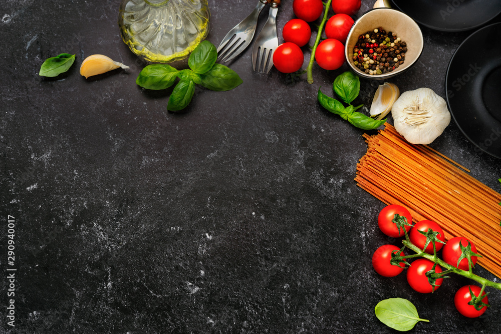 Wall mural Top view on dry pasta and fresh cherry tomatoes