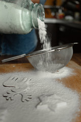 Fototapeta premium Girl puts flour in a sieve