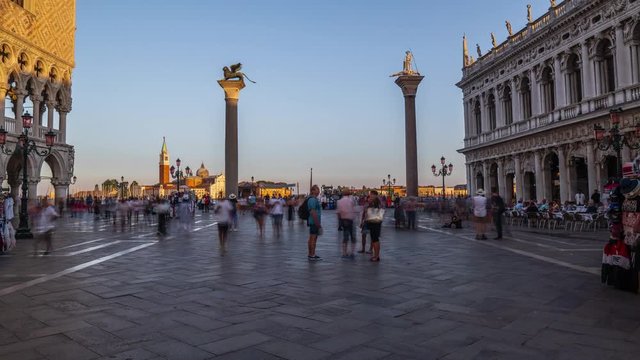Basilica of St Mark timelapse hyperlapse and San Marco campanile. It is cathedral church of Roman Catholic Archdiocese of Venice. It lies at Piazza San Marco. Tourists walking in front of it. Venice