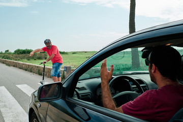 a driver having a problem with a man in an electric scooter