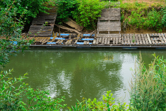 Broken jetty along river