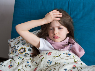 Obraz na płótnie Canvas portrait of a little unhappy sick girl with flu