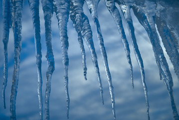 set of big icicles on sky background