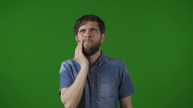 Toothache, Young Man with Toth Infection. Hand on his cheek, dissatisfaction and a little discomfort.