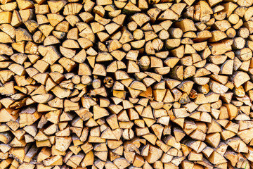 Chopped and stacked up dry firewood as background