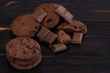 Chocolate cookies on wooden table. Homemade food on wooden background