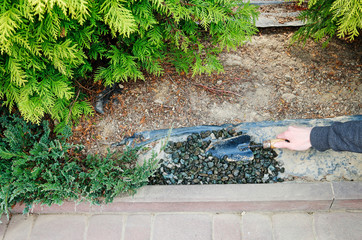 How to make a decoration from small pebbles next to a path in the garden.