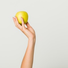 Close up of hand of young hispanic woman holding an apple