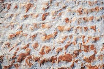 Natural stone texture with white and red colors.