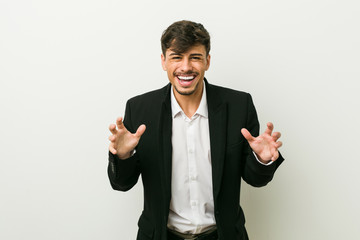 Young business hispanic man screaming with rage.