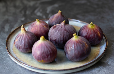 Fototapeta premium Ripe purple figs on dark background